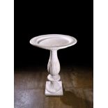 AN ITALIAN WHITE MARBLE FONT OR BIRD BATH 19TH CENTURY the dished circular top with an egg and