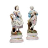 A PAIR OF CONTINENTAL BISCUIT PORCELAIN FIGURES LATE 19TH CENTURY of a well dressed gentleman and