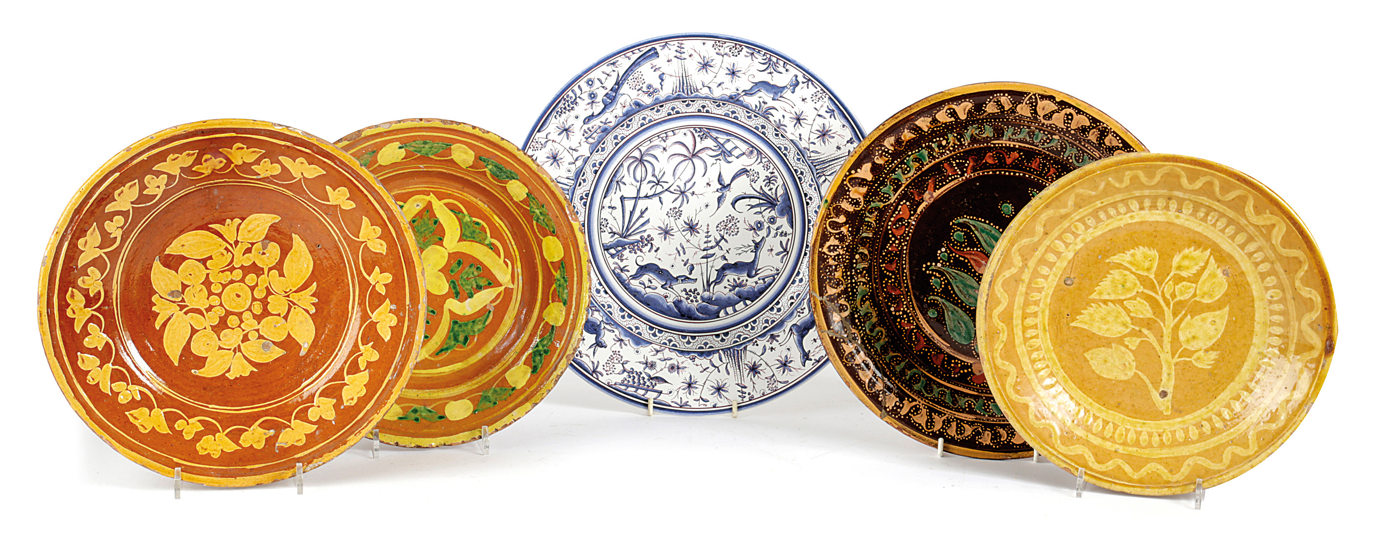 THREE SPANISH SLIPWARE POTTERY PLATES 19TH / 20TH CENTURY each painted with floral designs, together