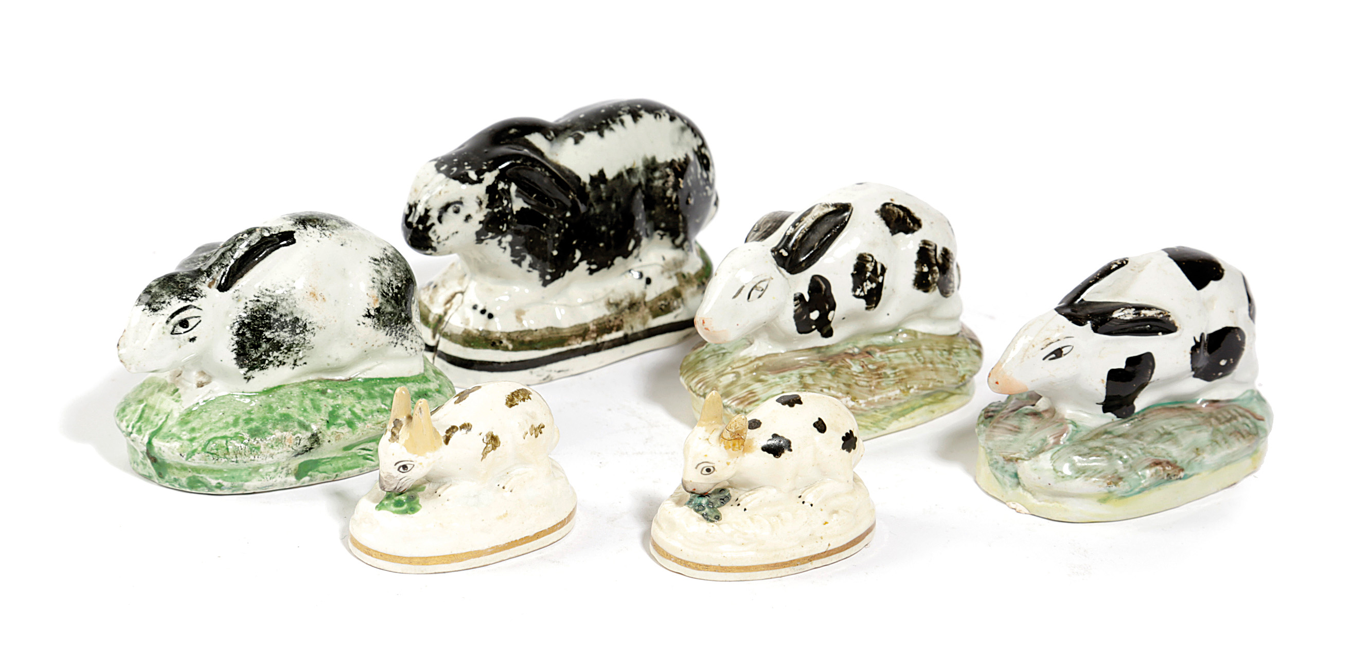 SIX POTTERY MODELS OF RABBITS 19TH CENTURY with a Scottish example with sponged decoration, c.1840