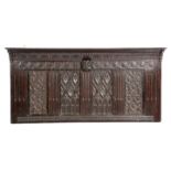 AN OAK OVERMANTEL 16TH CENTURY ELEMENTS AND LATER inset with two pairs of Gothic panels, with lancet