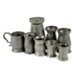 SEVEN PEWTER MEASURES 19TH CENTURY with various marks, together with a small mug, with a scroll