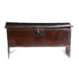 A BOARDED OAK COFFER EARLY 17TH CENTURY of five plank construction, the interior with a lidded till,