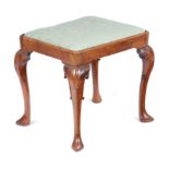 A GEORGE II WALNUT STOOL C.1735-40 with a later drop-in seat, on scroll carved hocked cabriole