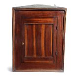 A LABURNUM HANGING CORNER CUPBOARD POSSIBLY SCOTTISH, EARLY 18TH CENTURY with a moulded edge and a