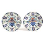 A PAIR OF DELFT POTTERY POLYCHROME CHARGERS 18TH CENTURY each painted in blue, green, red and yellow