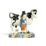 A YORKSHIRE PRATT WARE POTTERY COW AND FARMER GROUP C.1810 the large bovine standing four square,