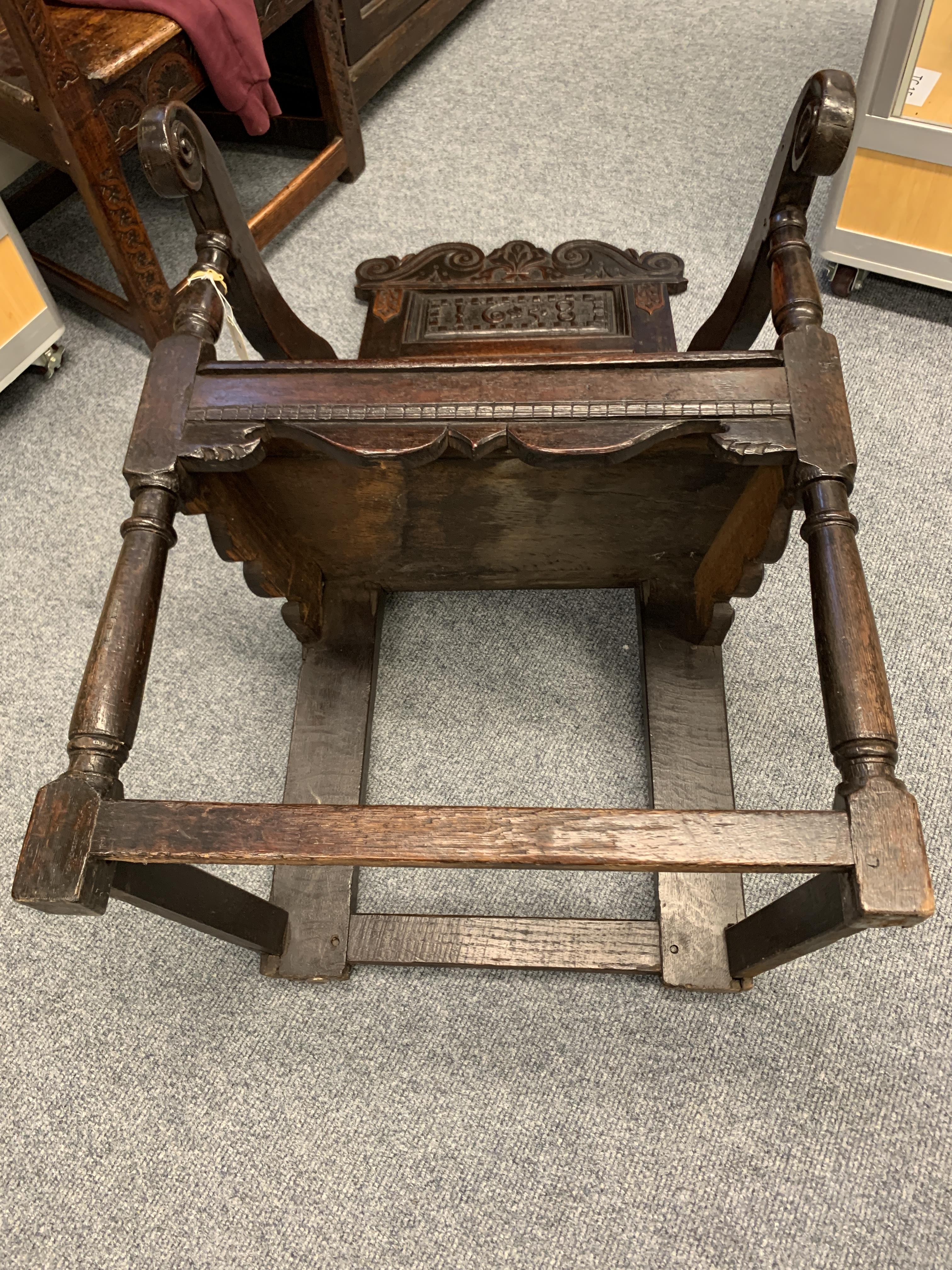 A CHARLES I OAK PANELLED BACK ARMCHAIR DATED '1638' the scroll carved crest centred with a fleur- - Image 11 of 13