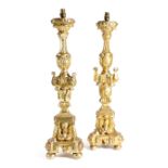 A PAIR OF ITALIAN GILTWOOD ALTAR CANDLESTICKS 18TH CENTURY with classical urn stems carved with