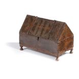 A SMALL WOODEN CHEST IN MEDIEVAL STYLE of ark shape and with incised zigzag decoration, with iron