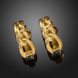 A pair of gold stirrup-form cufflinks by Boucheron, with stylised curve design bodies, the signed