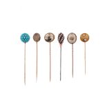 Six late 19th - early 20th century stick pins, two set with moss agate cabochons, one designed as