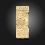 A 9ct gold Rollagas lighter by Alfred Dunhill, with stylised samarodock decoration, London marks for