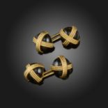 A pair of gold-mounted onyx cufflinks by Van Cleef & Arpels, the onyx cabochons with gold