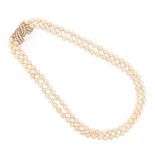 A two-row cultured pearl necklace, with a diamond-set bow clasp in gold, 54cm shortest