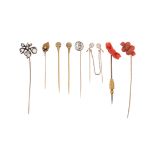 λ Eight 19th century stick pins, including a pair of Archaeological Revival gold stick pins with wh