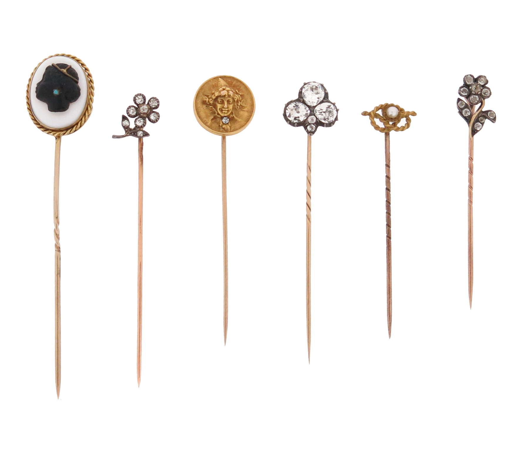 Six 19th - 20th century stick pins, including a diamond-set floral spray stick pin and a similar