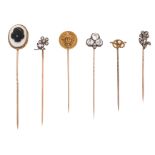 Six 19th - 20th century stick pins, including a diamond-set floral spray stick pin and a similar
