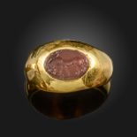 A Sassanian intaglio-set gold ring, the carnelian intaglio depicting an antelope in aggressive