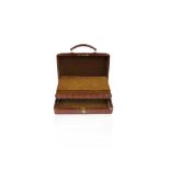 A brown leather rectangular jewellery case, the case with a hinged fold-up tray with compartments,