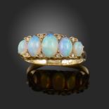 A late 19th century opal and diamond half-hoop ring, set with graduated opal cabochons and diamond