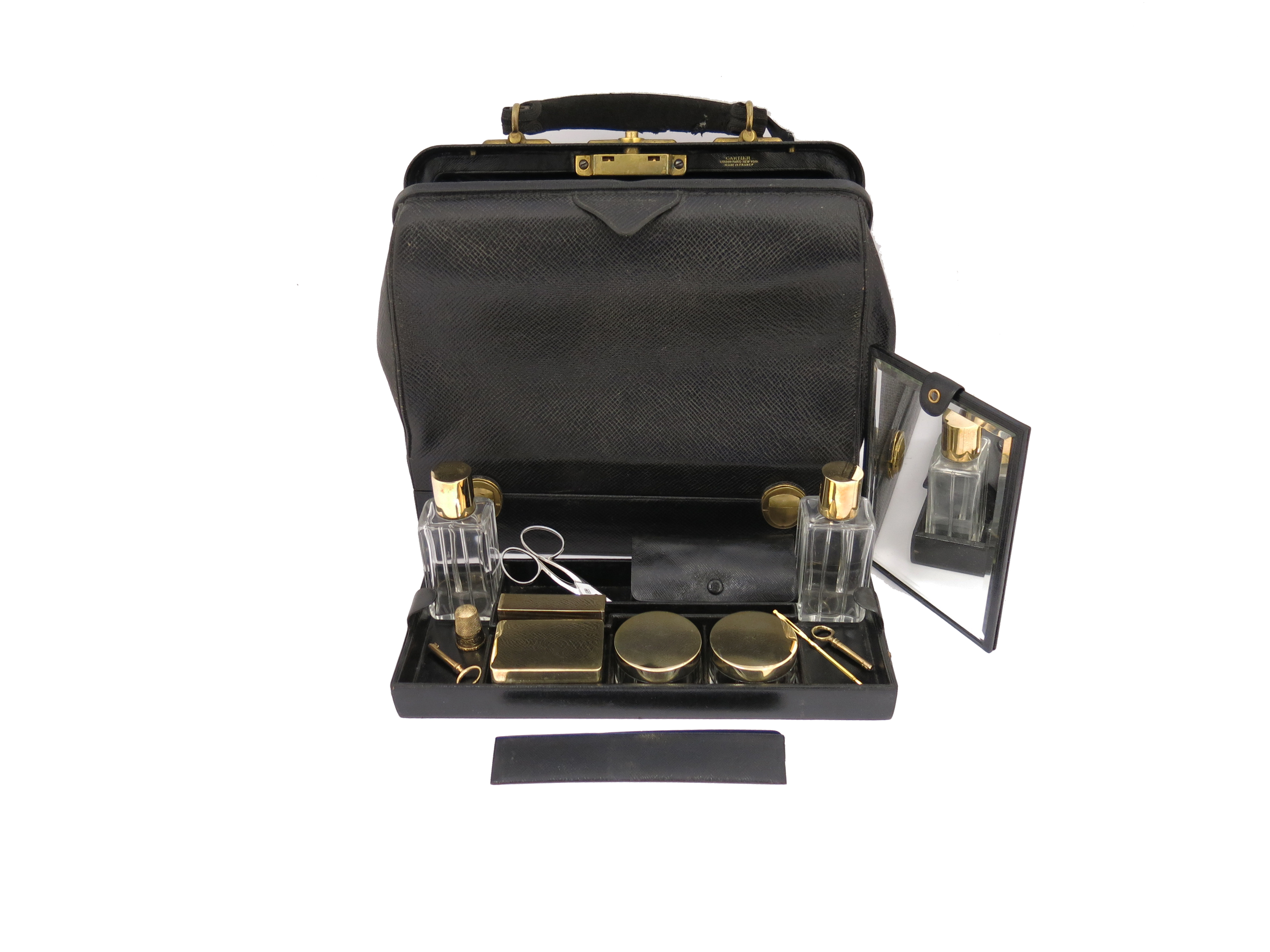 ? A black leather travel bag by Cartier, marked next to the lock 'Cartier London Paris New York,