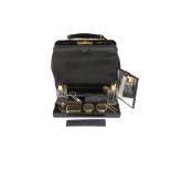 ? A black leather travel bag by Cartier, marked next to the lock 'Cartier London Paris New York,