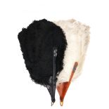 Two early 20th century ostrich plume fans, one with white feathers, the other with black feathers,