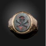 A late 19th century bloodstone intaglio ring, the oval bloodstone carved with a skull and cross