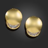 A pair of gold earrings by Gucci, set with demi-lune-shaped white stones in circular gold mounts,