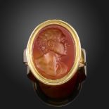 A late 18th century carnelian intaglio-mounted gold ring, the intaglio depicting a phiolospher in