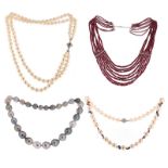 Four cultured pearl necklaces and a faceted ruby bead necklace