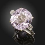 A kunzite and diamond ring, the cushion-shaped kunzite is set with baguette-shaped diamonds to