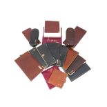 A quantity of leather wallets, including a red leather wallet with gilt metal corner mounts by