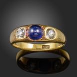 A late 19th century sapphire and diamond gold gypsy ring, set with a sugarloaf cabochon sapphire and