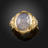 A Roman chalcedony intaglio mounted gold ring, the intaglio depicting Zeus with an eagle, c. 1st