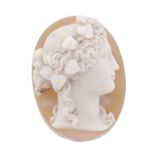 A carved hardstone cameo, depicting a female in profile with ivy leaves to her curling hair