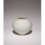 A KOREAN WHITE GLAZE MOON JAR MODERN, 20TH CENTURY The elegant bulbous body raised on a short foot