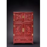 A RARE CHINESE IMPERIAL CINNABAR LACQUER 'DRAGON' CABINET QIANLONG 1736-95 The rectangular body with