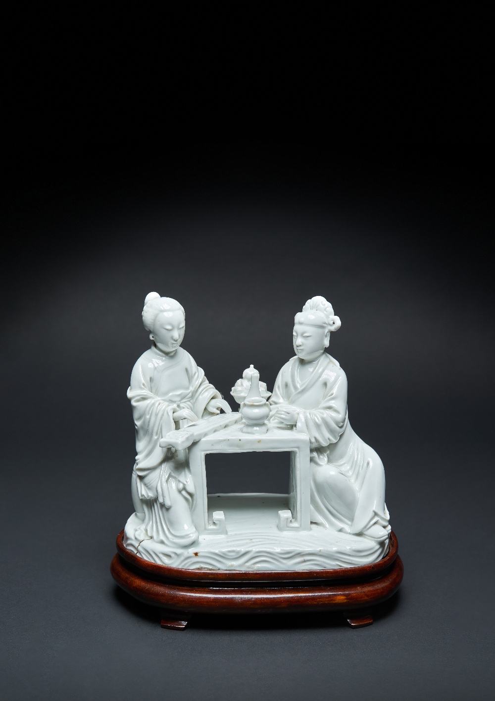 A RARE CHINESE BLANC DE CHINE GROUP EARLY 18TH CENTURY Modelled with a lady playing a qin, seated at