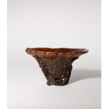 ? A LARGE CHINESE RHINOCEROS HORN 'LOTUS' LIBATION CUP 17TH/EARLY 18TH CENTURY Formed as a single