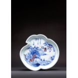 A RARE CHINESE UNDERGLAZE BLUE AND COPPER RED PEACH-SHAPED DISH EARLY KANGXI Painted with a