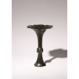 A CHINESE BRONZE FLARED GU-SHAPED VASE 17TH CENTURY The wide flaring neck and foot cast with a