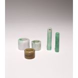 TWO CHINESE JADEITE ARCHER'S RINGS AND TWO HAT ORNAMENTS QING DYNASTY OR LATER The rings and hat