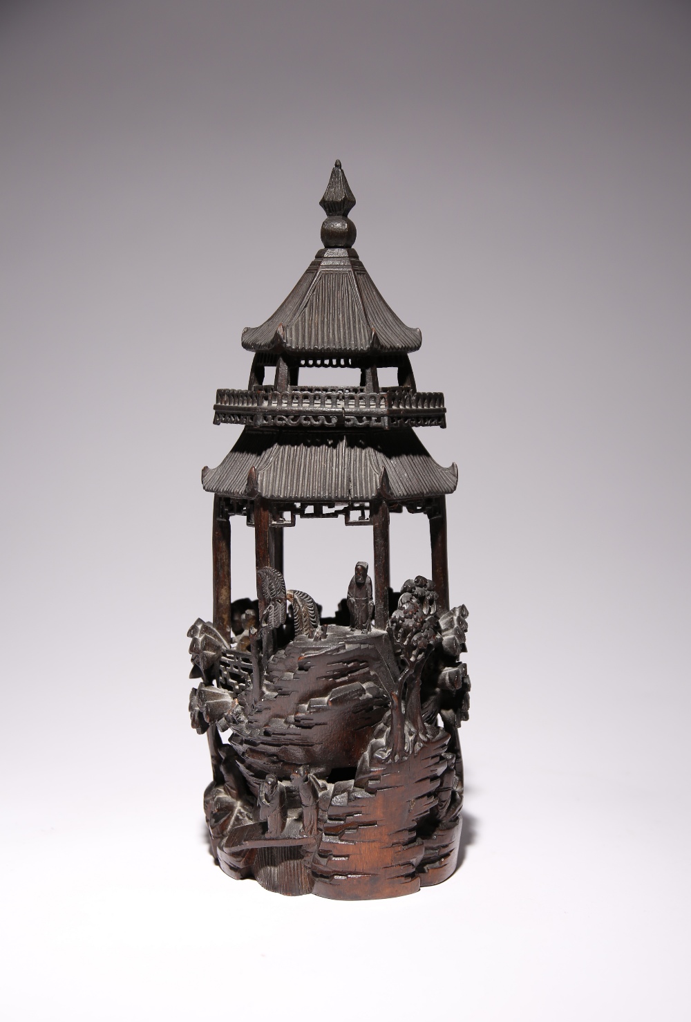 A CHINESE CARVED BAMBOO MODEL OF A PAGODA LATE QING DYNASTY With trees rising from rocks and with