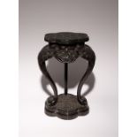 A TIHEI LACQUER TRIPOD STAND 18TH/19TH CENTURY The lobed top carved with concentric bands of