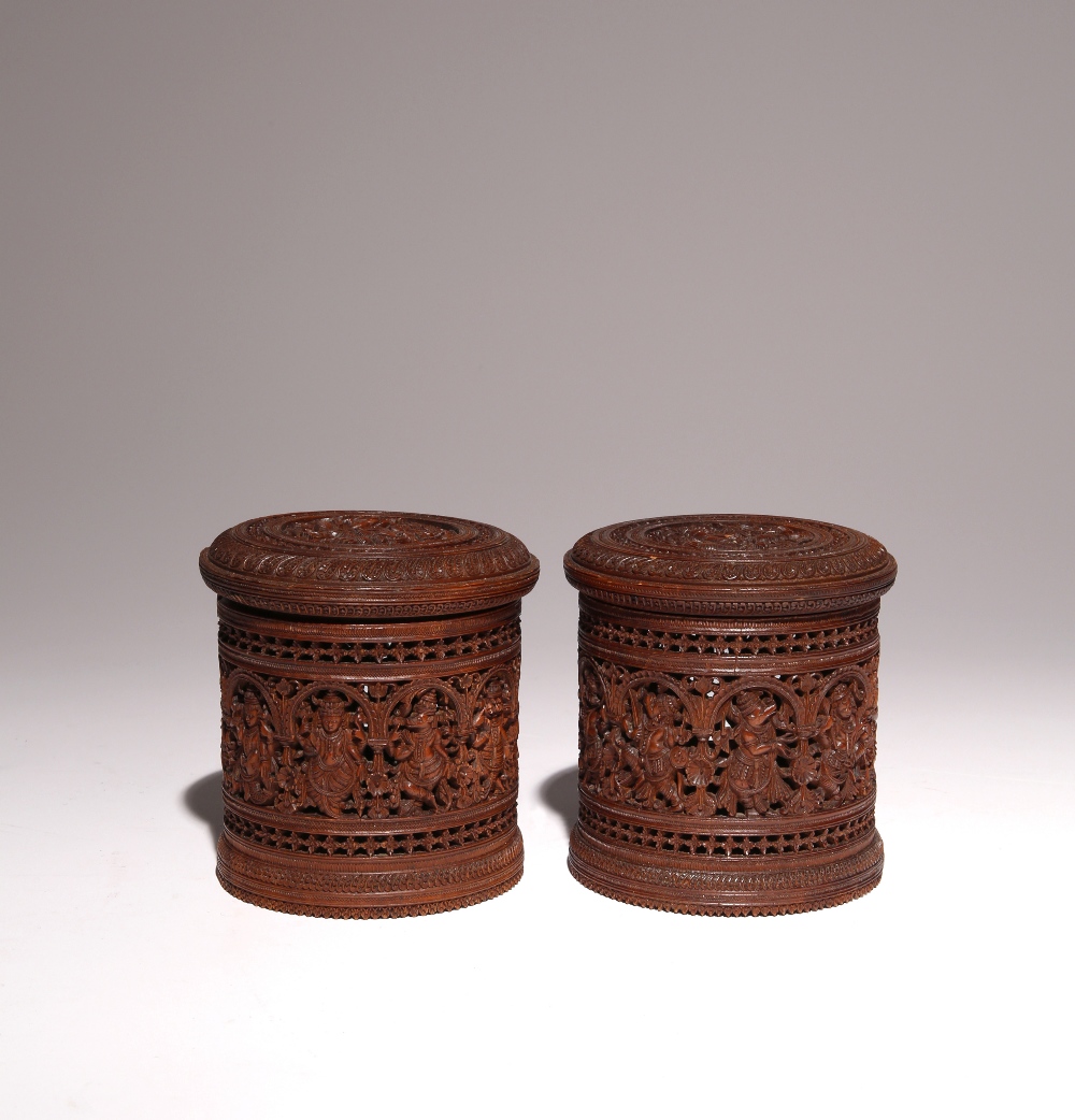 A PAIR OF INDIAN SANDALWOOD CYLINDRICAL BOXES AND COVERS LATE 19TH CENTURY Each cover carved with
