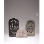 AN INDIAN STONE FRAGMENT AND A WOOD CARVING 19TH/20TH CENTURY The stone fragment decorated with a