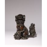 A CHINESE BRONZE 'LION DOG' INCENSE BURNER AND COVER LATE MING DYNASTY Cast with one paw resting