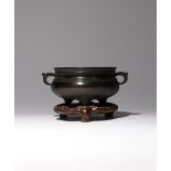 A CHINESE BRONZE TRIPOD INCENSE BURNER QING DYNASTY OR LATER The compressed body raised on three